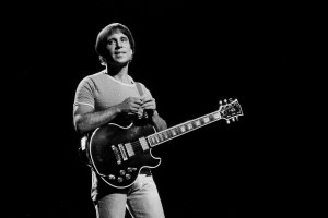 American Folk and Pop musician Paul Simon plays guitar as he performs onstage at the Auditorium Theater, Chicago, Illinois, September 25, 1980. (Photo by Paul Natkin/Getty Images)